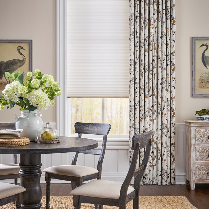 Cordless, inside mount light filtering cellular shades paired with the Easy Grommet Drapery. Shade Color: Papyrus GS1104; Drapery Color: Le Jardin Tan-Grey 1025